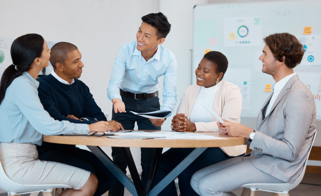 A young professional sharing his sales skills with colleagues